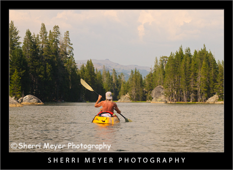 Man kayaking on Utica Reservoir, Alpine County, California.